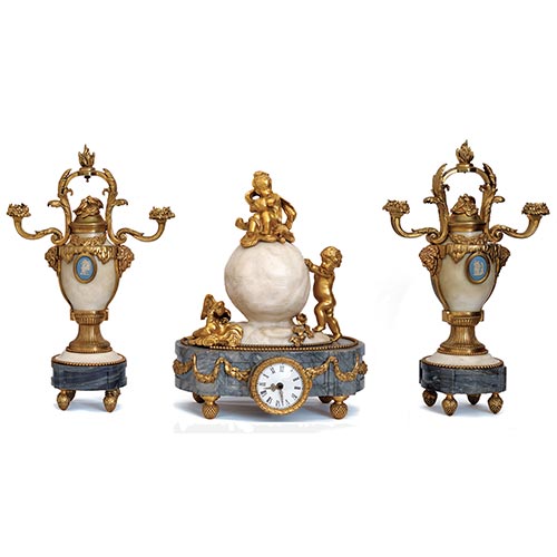 Sub.:25 - Lote: 256 -  Guarnicin de reloj estilo Luis XVI realizado en mrmol blanco y gris Santa Ana, con monturas en bronce dorado. 