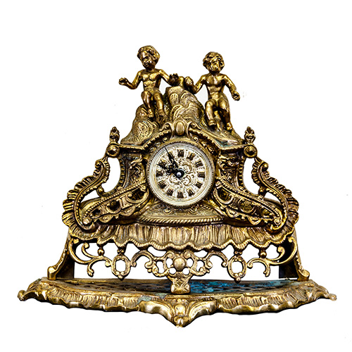 Sub.:10 - Lote: 1462 -  Reloj de sobremesa en bronce dorado. Esfera de numeracin romana flanqueada por volutas estiradas, y tico coronado por figuras de dos nios.