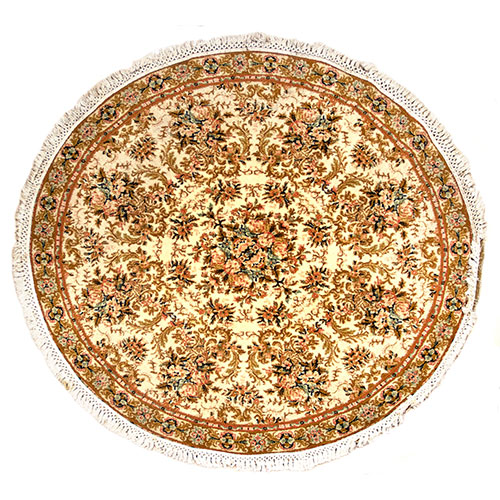 Sub.:12-On - Lote: 57 -  Alfombra redonda en nudo español con decoración floral sobre fondo beige.