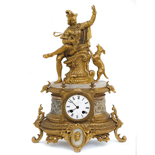 Sub.:21 - Lote: 244 -  Reloj de sobremesa en calamina dorada y alabastro con figura de cazador.