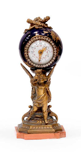Sub.:35 - Lote: 236 -  Peque�o reloj de colecci�n en calamina y porcelana sobre base de m�rmol rosa
